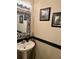 Stylish half bathroom featuring a zebra-print framed mirror and modern fixtures at 5114 Hawkstone Dr, Sanford, FL 32771