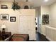 Hallway featuring hardwood floors, a white door, desk and decorative plant at 5114 Hawkstone Dr, Sanford, FL 32771
