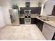 Modern kitchen showcasing stainless steel appliances, granite countertops, and dark wood cabinetry at 5114 Hawkstone Dr, Sanford, FL 32771