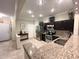 Well-lit kitchen featuring granite countertops, stainless steel appliances, and dark wood cabinetry at 5114 Hawkstone Dr, Sanford, FL 32771