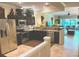 Spacious kitchen featuring dark cabinetry, granite countertops, and stainless steel appliances at 5114 Hawkstone Dr, Sanford, FL 32771