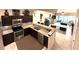 Modern kitchen with stainless appliances and granite countertops that open to an inviting living space at 5114 Hawkstone Dr, Sanford, FL 32771