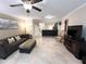 Comfortable living room featuring neutral tile flooring and furniture, with an open view to the kitchen bar at 5114 Hawkstone Dr, Sanford, FL 32771