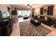 Comfortable living room featuring neutral tones, stylish zebra rug, and access to the screened in patio at 5114 Hawkstone Dr, Sanford, FL 32771