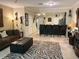 Open-concept living room leading to a bar and kitchen with stylish decor and ample seating at 5114 Hawkstone Dr, Sanford, FL 32771