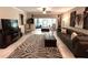 Living room with zebra print rug and serene view of screened porch overlooking backyard at 5114 Hawkstone Dr, Sanford, FL 32771