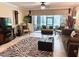 Bright living room with tiled floors, stylish zebra rug, and sliding glass doors to patio at 5114 Hawkstone Dr, Sanford, FL 32771