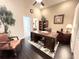 Elegant home office featuring dark wood furniture, a large desk, and a view into an en-suite bathroom at 5114 Hawkstone Dr, Sanford, FL 32771