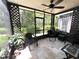 Screened-in patio featuring stylish decor, ceiling fan, comfortable seating and a view of the backyard at 5114 Hawkstone Dr, Sanford, FL 32771