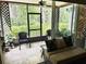 Cozy screened-in porch with comfortable seating, lush plants, and tranquil outdoor views at 5114 Hawkstone Dr, Sanford, FL 32771