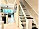 Bright staircase features glass panels, white risers, and dark treads at 5114 Hawkstone Dr, Sanford, FL 32771