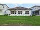 Exterior view of the back of the home showcasing the tile roof and well manicured lawn at 5254 Citrus Leaf Blvd, Winter Garden, FL 34787