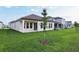 Exterior view of the back of the home showcasing the tile roof and well manicured lawn at 5254 Citrus Leaf Blvd, Winter Garden, FL 34787