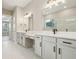 Bathroom featuring dual sinks, white cabinets, and a modern glass enclosed shower at 5254 Citrus Leaf Blvd, Winter Garden, FL 34787