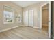 A bright bedroom with wood floors, closet, and natural light at 5254 Citrus Leaf Blvd, Winter Garden, FL 34787