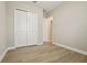 A lovely bedroom includes wood flooring, closet, and doorway to another room at 5254 Citrus Leaf Blvd, Winter Garden, FL 34787