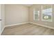 Bedroom with wood floors and natural light from the large windows at 5254 Citrus Leaf Blvd, Winter Garden, FL 34787