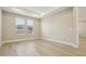 A modern bedroom features hard wood floors and large windows at 5254 Citrus Leaf Blvd, Winter Garden, FL 34787