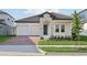 Charming single-story home featuring a brick driveway, stone accents, and a neatly landscaped front yard at 5254 Citrus Leaf Blvd, Winter Garden, FL 34787