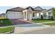 Charming single-story home features a stone facade, tile roof and a two-car garage at 5254 Citrus Leaf Blvd, Winter Garden, FL 34787