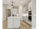 Modern kitchen featuring a center island, stainless steel appliances, and light hardwood floors at 5254 Citrus Leaf Blvd, Winter Garden, FL 34787