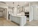 A modern kitchen featuring stainless steel appliances, a center island, and light hardwood floors at 5254 Citrus Leaf Blvd, Winter Garden, FL 34787