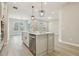 Open concept kitchen with stainless steel appliances, a center island, and hardwood floors at 5254 Citrus Leaf Blvd, Winter Garden, FL 34787
