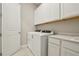 Bright laundry room features modern appliances, white cabinetry, and stylish countertop with sink at 5254 Citrus Leaf Blvd, Winter Garden, FL 34787