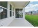 Covered patio with sliding glass doors overlooking the lush green yard at 5254 Citrus Leaf Blvd, Winter Garden, FL 34787