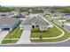 Aerial view of a single-story home with a well-manicured lawn and lush landscaping in a suburban neighborhood at 5393 Red Coral Cir, Mount Dora, FL 32757
