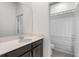 Bright bathroom featuring a modern vanity, neutral countertop, and shower with a patterned curtain at 5393 Red Coral Cir, Mount Dora, FL 32757