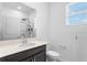 Contemporary bathroom with a sleek vanity, quartz countertop, black hardware, and walk-in shower at 5393 Red Coral Cir, Mount Dora, FL 32757