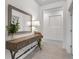 Inviting foyer featuring a decorative console table, a large mirror, and stylish tiled flooring at 5393 Red Coral Cir, Mount Dora, FL 32757