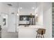 Open-concept kitchen featuring a breakfast bar, stainless steel appliances, and modern pendant lighting at 5393 Red Coral Cir, Mount Dora, FL 32757