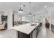 Spacious kitchen with a large island flowing into the living and dining areas at 5393 Red Coral Cir, Mount Dora, FL 32757