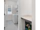 Well-organized laundry room with modern washer and dryer, storage shelves, and convenient countertop space at 5393 Red Coral Cir, Mount Dora, FL 32757