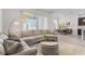 Bright living room with a large sectional sofa and a view into the dining area at 5393 Red Coral Cir, Mount Dora, FL 32757
