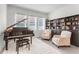 Elegant living room featuring a grand piano, comfortable seating, and bright natural light from large windows at 5393 Red Coral Cir, Mount Dora, FL 32757
