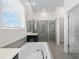 Well-lit bathroom showcasing a soaking tub and a glass-enclosed shower at 5393 Red Coral Cir, Mount Dora, FL 32757