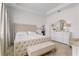 Serene main bedroom with a tufted headboard, matching bench, and ample natural light at 5393 Red Coral Cir, Mount Dora, FL 32757