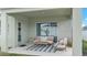 Stylish covered patio with neutral furniture, a striped rug, and a serene outdoor view at 5393 Red Coral Cir, Mount Dora, FL 32757