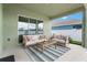 Inviting covered patio with comfortable seating, a striped rug, and a view of the backyard at 5393 Red Coral Cir, Mount Dora, FL 32757