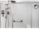 Modern walk-in shower featuring sleek black fixtures, including a rainfall showerhead and convenient dispenser at 5393 Red Coral Cir, Mount Dora, FL 32757