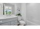 Bright bathroom featuring a gray vanity, white countertops, and a shower-tub combination at 6009 Tree Crossing Ln, St Cloud, FL 34771
