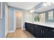 Modern bathroom featuring double vanity with dark cabinets and stylish fixtures at 6009 Tree Crossing Ln, St Cloud, FL 34771