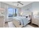 Serene bedroom featuring wood floors, a large window, and a comfortable bed with blue accents at 6009 Tree Crossing Ln, St Cloud, FL 34771