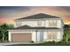 Two-story home featuring a two-car garage, neutral colors, and well-manicured lawn at 6009 Tree Crossing Ln, St Cloud, FL 34771