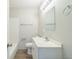 Functional bathroom with a large mirror, vanity sink, and a shower-tub combo at 6042 Bolling Dr, Orlando, FL 32808