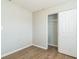 Cozy bedroom with wood-look flooring and a closet featuring sliding doors for storage at 6042 Bolling Dr, Orlando, FL 32808