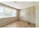 Bedroom featuring wood-look flooring and a large window with blinds at 6042 Bolling Dr, Orlando, FL 32808